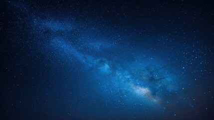 Starry night sky with deep blue hues, stars scattered across the horizon, and subtle distant light
