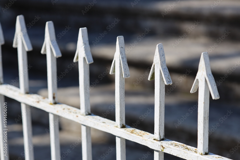 Poster close-up shot of a metal fence with arrows, suitable for use in various contexts
