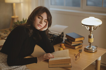 Young Woman Asleep Over Book In Cozy Study Room With Warm Lighting 