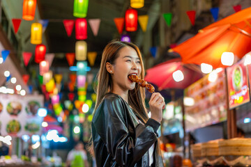 Asian woman enjoying street food at Chiang Mai Walking Street Night Bazaar. Young traveler exploring vibrant night market in Thailand.