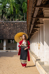 Asian woman in traditional Lanna dress at Wat Intharawat, Chiang Mai. Portrait of young Thai woman...