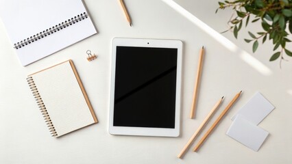 Clean desk setup with tablet notebooks and pencils