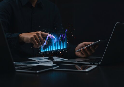 Financial analyst examining holographic stock market data with laptop and smartphone - Powered by Adobe
