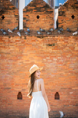 Asian tourist woman enjoying travel moments at Tha Phae Gate, Chiang Mai. Young woman in white...