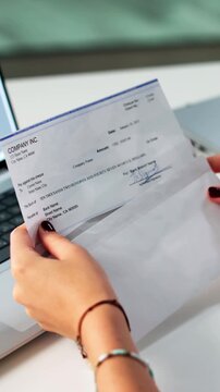 Work Compensation: Holding Payroll Check Envelope