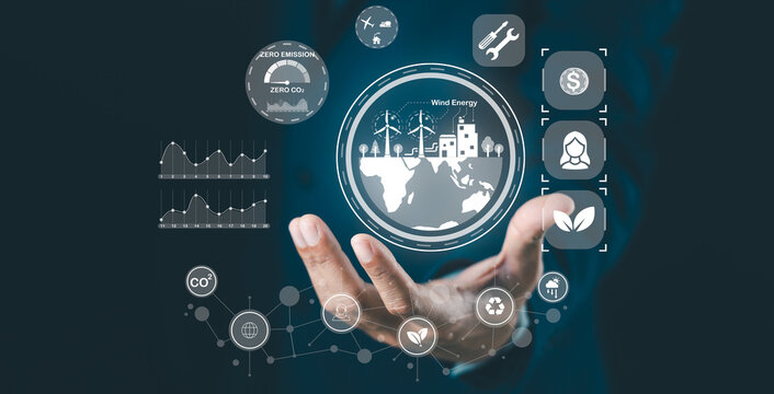 A hand holds a digital globe with eco-friendly icons representing renewable energy, zero emissions, and sustainability on a dark blue background with network connections.