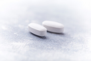 Amino acids tablets on wooden background. Soft focus. Close up	