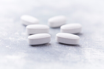 Amino acids tablets on wooden background. Soft focus. Close up	