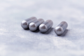 BCAA amino acids tablets. Nutrition for bodybuilding. Fitness supplements on bright background. Soft focus. Copy space.	