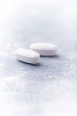 Amino acids tablets on wooden background. Soft focus. Close up	