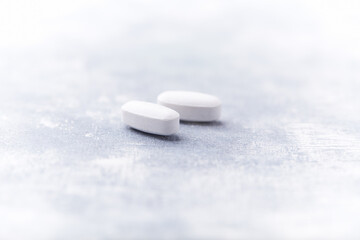 Amino acids tablets on wooden background. Soft focus. Close up	