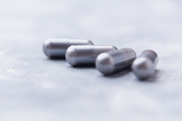 BCAA amino acids tablets. Nutrition for bodybuilding. Fitness supplements on bright background. Soft focus. Copy space.	