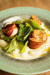 Gnocchi with creamy sauce and bacon-wrapped chicken