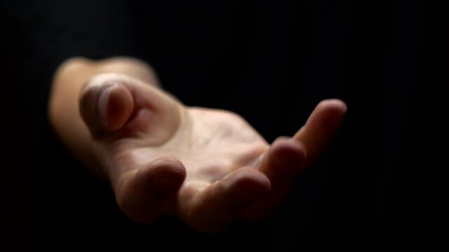 A surge of adrenaline and severe stress in a man on a black background.
Trembling in the limbs and tremors of the hands caused by problems with the nervous system.
Parkinson's disease in a man 