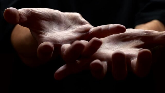 A surge of adrenaline and severe stress in a man on a black background.
Trembling in the limbs and tremors of the hands caused by problems with the nervous system.
Parkinson's disease in a man 