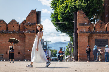 Asian Woman Walking in Front of Tha Phae Gate Chiang Mai. Female Tourist Exploring Famous Landmark...