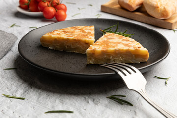 Spanish omelette portions served on black dish 