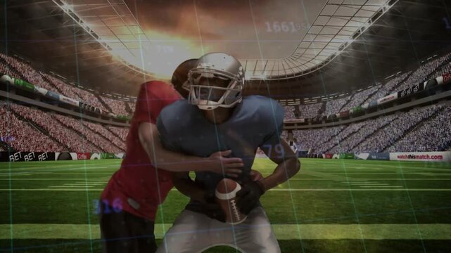 Football player in blue jersey catching ball then securing before red defender driving fumble
