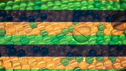 Colorful translucent marbles arranged in horizontal stripes of green, blue, and amber tones....