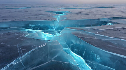 Stunning Cracked Blue Ice Surface on a Frozen Lake at Sunrise