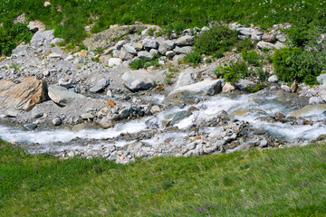 Scenic view of stream with rocks and splashing water at Lötschental Valley in the Swiss Alps on a sunny late spring day. Photo taken June 19th, 2025, Lötschental, Switzerland.
