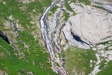 Scenic view of stream with rocks and splashing water at Lötschental Valley in the Swiss Alps on a...