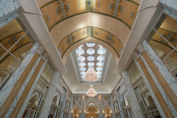 Elegant architectural interior with ornate ceilings, columns, and chandeliers. Luxurious decoration...