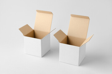 Square white cardboard box with kraft interior mockup on neutral background