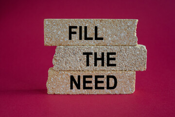 Brick blocks with words Fill the need on a beautiful red background. Business, financial and fill...