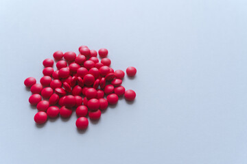 Heap of bright red medicine. Daily healthcare and pharmaceutical treatment. Abstract pill pharmacy visual. Idea concept of healthcare and illness. Concept of drug and supplement or vitamin