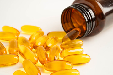 Fish oil or Cod liver oil gel in capsules with omega 3 vitamins, supplementary healthy food.
