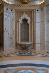Ornate marble alcove with intricate mosaic and decorative bowl, surrounded by luxurious geometric...