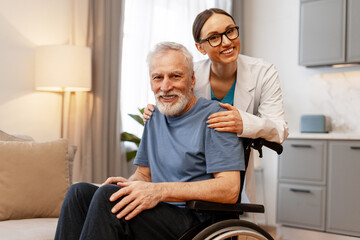 Doctor comforting senior man in wheelchair at home or nursing home