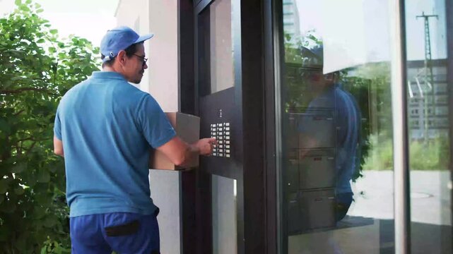 Delivery Man Using Intercom System For Entry