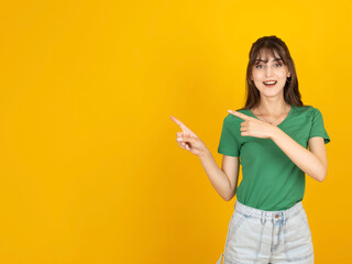 Pointing fingers aside, young caucasian brunette 20s excited happy smiling woman pointing fingers...