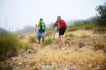 Two Hikers on a Foggy Mountain Trail Embracing the Outdoors
