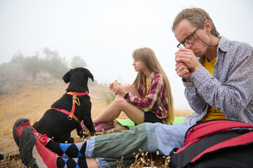 Outdoor Exploration With Friends and Dog on Foggy Day in Scenic Mountains
