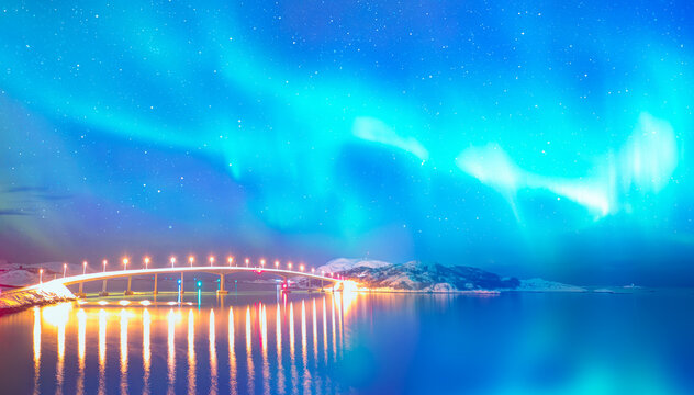 Sommaroy Bridge is a cantilever bridge connecting the islands of Kvaloya and Sommaroy with Aurora Borealis - Hillesoy Tromso Norway