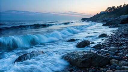 Serene coastal landscape at sunset with gentle waves lapping against rocky shoreline