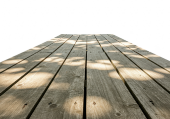 A perspective view of a weathered wooden plank deck with dappled sunlight and shadows isolated on transparent background