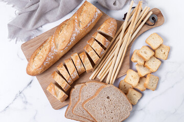 Assortment of Bread Products on white marble background