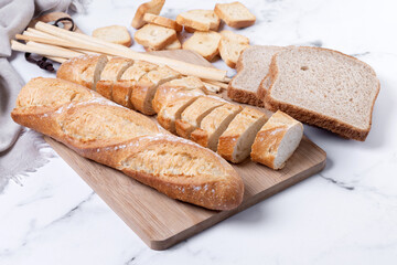 Assortment of Bread Products on white marble background