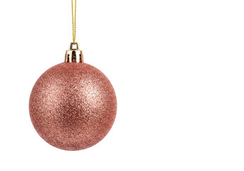 A rose gold glitter christmas ornament hangs from a gold string, isolated on a transparent background