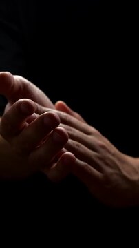The viewer applauds with his hands during a performance against a black background.
The theater spectator claps the lessons, a bravo or bravissimo gesture.
Delight and spectacle