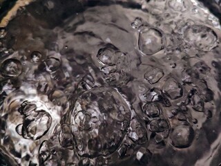 Abstract Macro of Bubbles in Dark Liquid Dynamic Texture and Reflections.