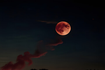A red full moon in the night sky