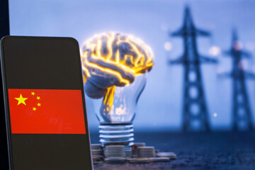 A Chinese flag displayed on a mobile screen held in a hand, with power lines in the background...