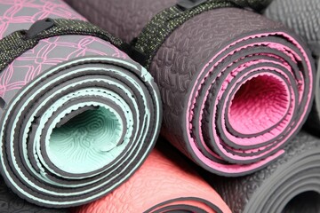 Stack of Rolled Yoga Mats with Various Designs