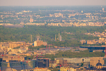 Panoramic view of the skyscrapers of La Défense and the Bois de Boulogne with its attractions during the Golden Hour at sunset in Paris, France.