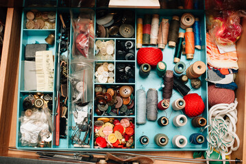 drawer with threads, needles and buttons